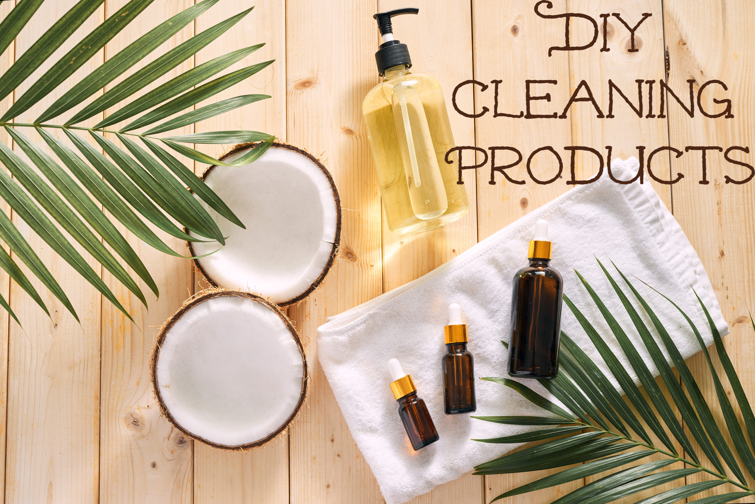 Cracked coconut and a bottle of oil on the table - spa, skincare, haircare and relaxation concept