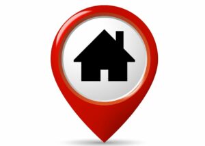 This is an image of a red location pin with an image of a black house icon in the middle