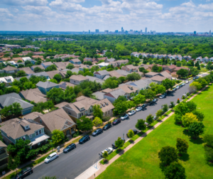 This is an image of a neighborhood with a city skyline in the background.