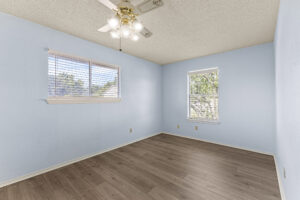 Secondary bedroom with mulitple windows for natural light at condo for rent.