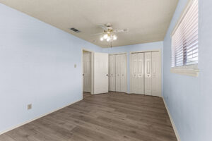 Secondary bedroom with hard floors, natural light and private closet at condo for rent.