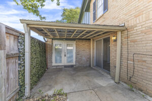 Covered, enclosed patio with entrace from kitchen and primary bedroom at condo for rent.
