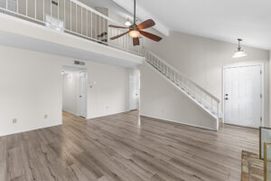 Living room with vaulted ceilings and access to primary bedroom at 2100 Kippling Drive #128
