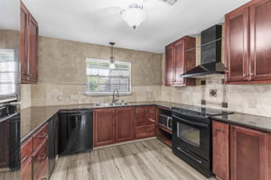 Kitchen with black appliance, countertop and storage.