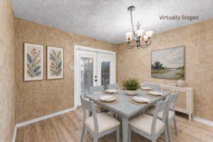 Virtually staged dining room with French doors, chandelier, and hard flooring at 2100 Kippling Drive.